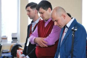 Mission trip team members praying with local church planter during 2026 European outreach in Spain