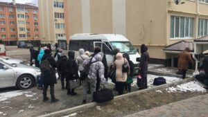 Ukrainian Christians and mission trip participants praying together during 2026 humanitarian relief outreach