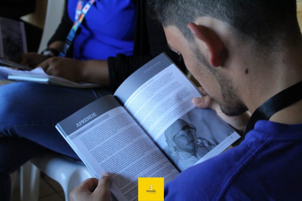 Young man reading the Storyline Study book, a Bible study used to prepare mission trip teams
