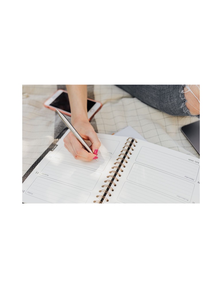 Christian taking notes during bible study on missions with world map, showing engaged learning and action planning